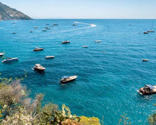 View of the Tyrrhenian sea coast in Positano, Italy. Multiple boats in the water