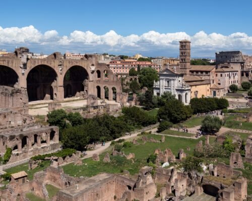 Roman Forum in the city of Rome, Italy. To the left is the Basilica of Maxentius, center is the Temple of Venus and Rome and on the far right is the Colosseum.