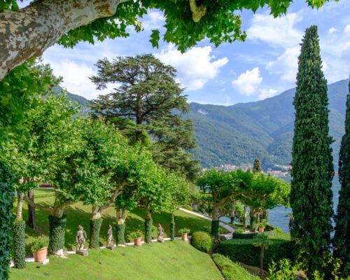 Villa Balbianello yard with green trees and ornaments. Sunny day. Lake Como, Italy