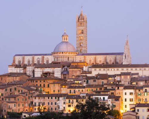 Cityscape view of Siena Cathedral at dusk, Siena, Tuscany, Italy